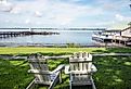 Two chairs on a green lawn overlooking Dora Lake and piers. Editorial credit: Marty-Mac / Shutterstock.com