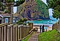 Two brothers at the end of a public beach access path at Cannon Beach, Oregon, with the stunning coastline and Haystack Rock.