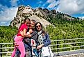 Happy family visiting Mt Rushmore tourist attraction in South Dakota.