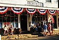 People gather and talk to friends in front of the general store in Brewster, Massachusetts. Image credit James Kirkikis via Shutterstock.