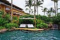 View of the Four Seasons Resort Lanai, an upscale luxury hotel next to Hulopoe Beach on the Pacific Ocean. Image credit EQRoy via Shutterstock.