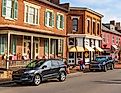 A woman and her dog walk along main street in Jonesborough decorated for Thanksgiving.