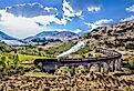 Glenfinnan Railway Viaduct in Scotland with the Jacobite steam train against sunset over lake. Image credit: Tomas Marek via Shutterstock