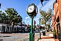 Downtown in nice day with clock, store fronts, restaurant and blue sky on Elm Street