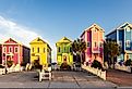 A row of colorful beachfront homes on a beautiful afternoon on St George Island, Florida. Image credit H.J. Herrera via Shutterstock