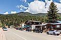 Main Street of Red River, New Mexico, with mountains in background.