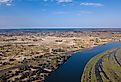 Aerial landscape in Okavango delta on Namibia and Angola border. River with shore and green vegetation after rainy season. Image credit Artush via Shutterstock. 