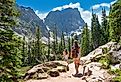 Girls on summer vacation hiking trip in the mountains, hiking on Emerald Lake Trail, Estes Park, Rocky Mountains National Park, Colorado.