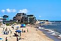 View of people and vacation homes on the beach as seen from the Rodanthe Pier in the Outer Banks