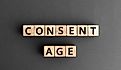 The words "Consent Age" formed from wooden blocks with letters.