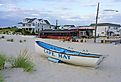 Cape May sign on the beach in Cape May, New Jersey. Image credit EQRoy via Shutterstock