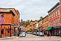 People walking down the sidewalks on historical Main Street in Galena, Illinois. Image credit Nejdet Duzen via Shutterstock