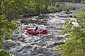 Whitewater rafters enjoy floating over the Mad Dog Rapid on Cache La Poudre River, west of Fort Collins. Editorial credit: marekuliasz / Shutterstock.com