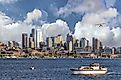 Seattle, Washington, city skyline from Lake Union with white clouds and blue sky. 