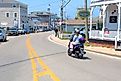 Moped driver and passenger navigating the roads of New Shoreham. Editorial credit: Ray Geiger / Shutterstock.com