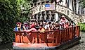 Boat full of tourists sightseeing the downtown from San Antonio River. Editorial credit: Moab Republic / Shutterstock.com