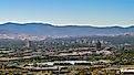 Reno-Sparks cityscape as seen from the East looking West with hotels, casinos and many other businesses and industry on a hazy autumn day. Editorial credit: Gchapel / Shutterstock.com