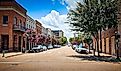 Cars parked along city street in downtown Natchez on a summer day. Editorial credit: VioletSkyAdventures / Shutterstock.com