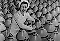 Canadian woman munitions worker tightening the nose plugs on 500-pound aerial bombs.