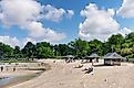 Panoramic view over the beach of Greenwich Point Park or Tods Point with number of people enjoying the beach and sun