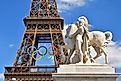 he statue on the Iéna Bridge and the Eiffel Tower adorned with the Olympic symbol. Image by noriox via Shutterstock.com