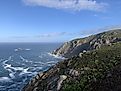 The blue expanse of the North Atlantic Ocean meets the steep cliffs of Cape Finisterre on the West Coast of Spain.