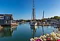 Boats and homes along the water with flowers blooming in Kennebunkport, Maine.