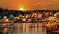 Lobster boats at anchor and bay front homes, Stonington, Maine. 