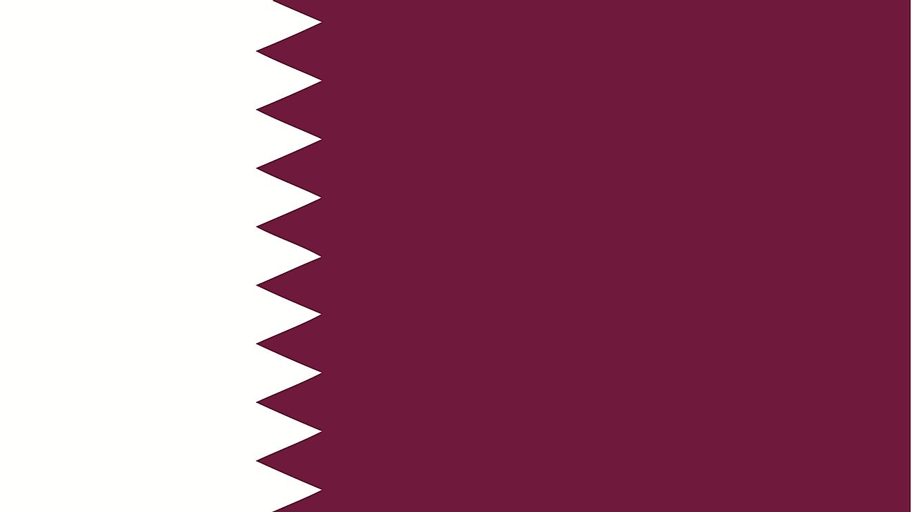 The National Flag of Qatar features a wider maroon band on the fly side, with a broad white serrated band (nine white points) on the hoist side of the flag.