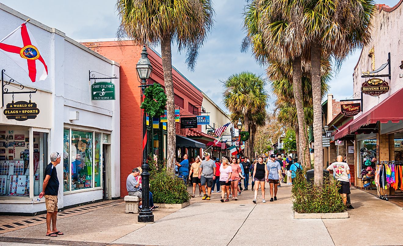 Large groups of visitors and tourists explore the array of shops near the end of Saint George street in Saint Augustine, Florida on an early January afternoon.