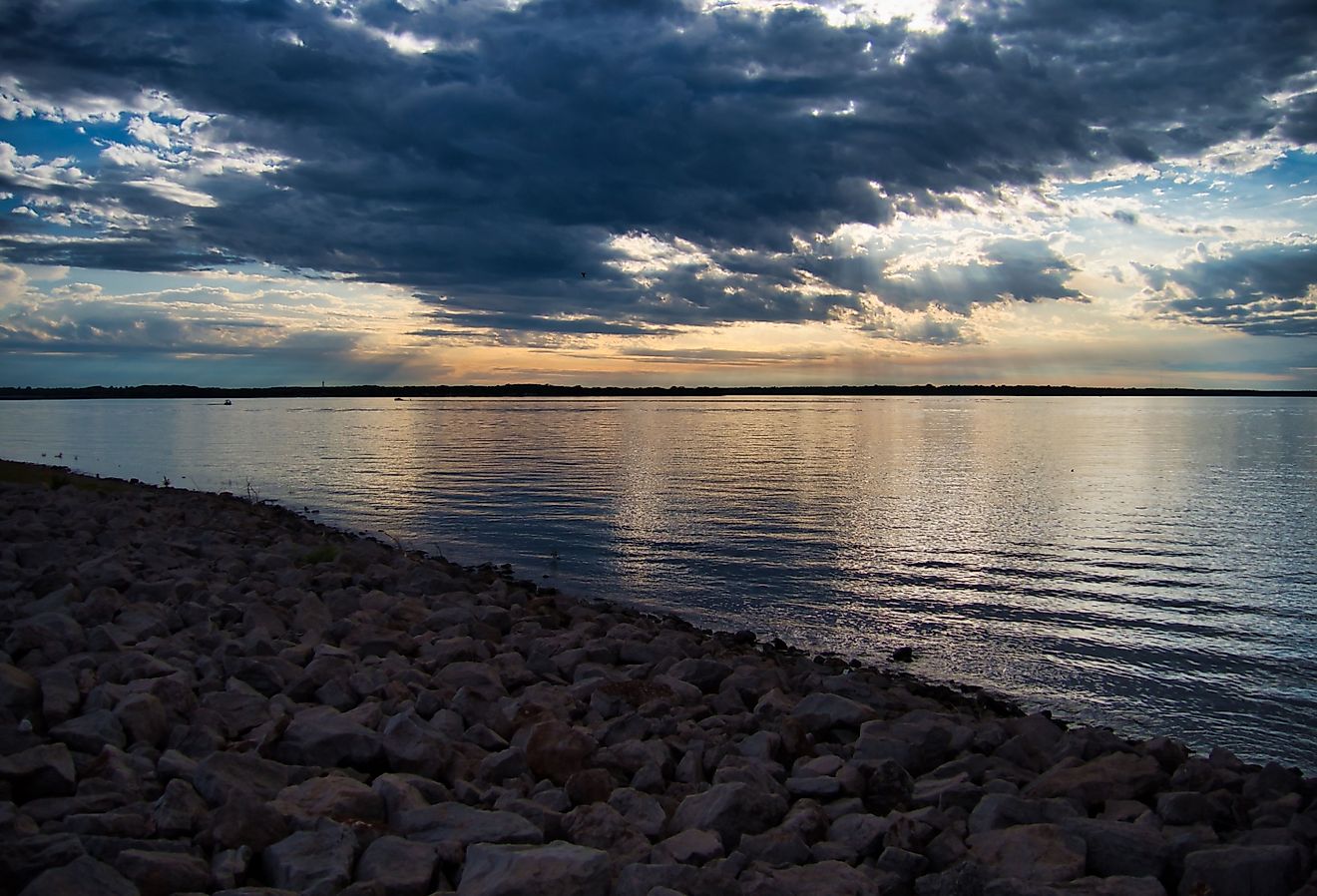 The scenic Hillsdale Lake and its rocky coast at sunset in Kansas.