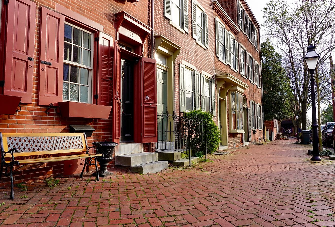 The historic New Castle Green in New Castle, Delaware, surrounded by colonial-era homes, public buildings, roads, and modern-day statues and historic markers. Editorial credit: George Wirt / Shutterstock.com