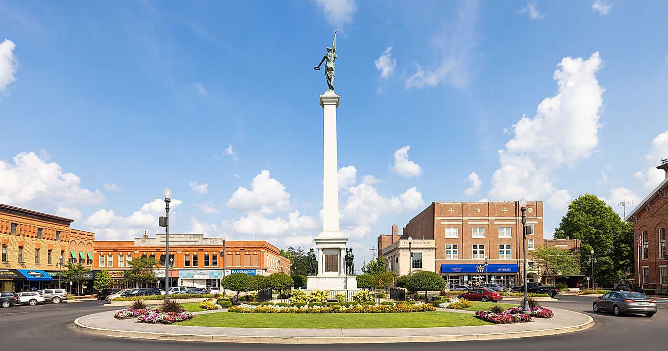 The Steuben County Soldiers Monument surrounded by rustic buildings in downtown Angola, Indiana. Editorial credit: Roberto Galan / Shutterstock.com