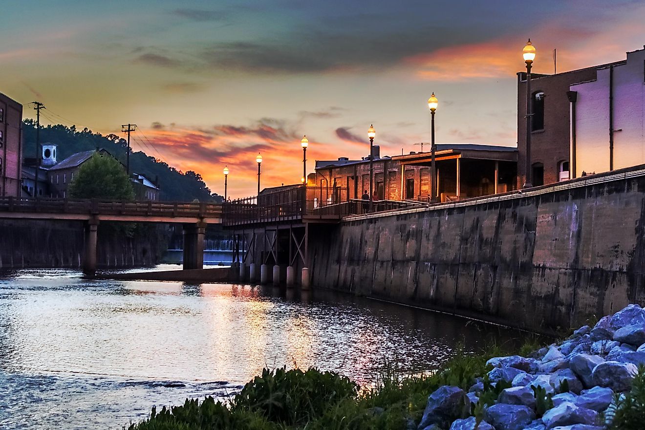 The Creekwalk and dam waterfall in Prattville, Alabama, is a popular spot for locals and visitors to enjoy the natural beauty of the area, especially during dusk.