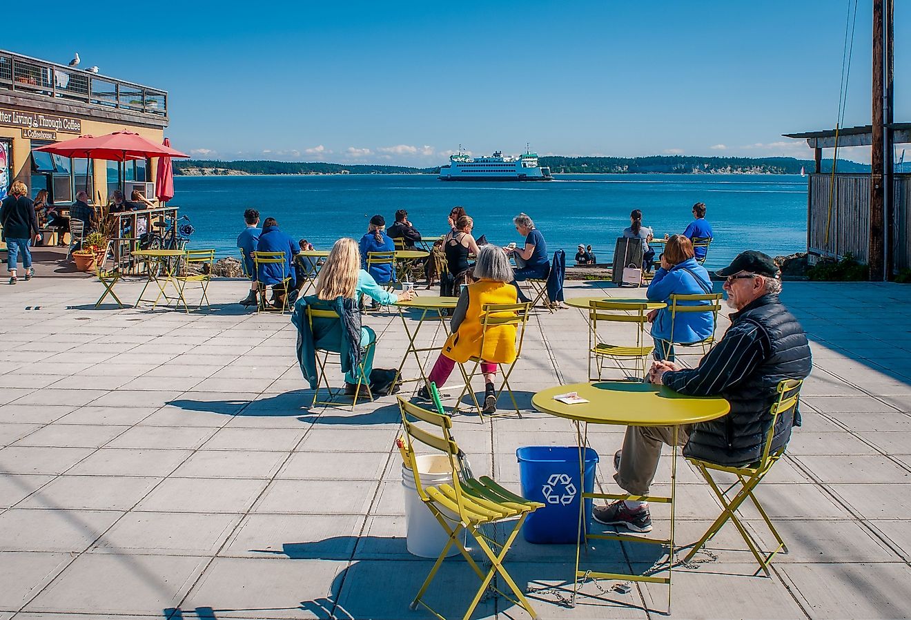 Washington State ferry Kennewick steams out of Port Townsend past the Main Street Plaza where people enjoy the sunny day. Image credit Gareth Janzen via Shutterstock.