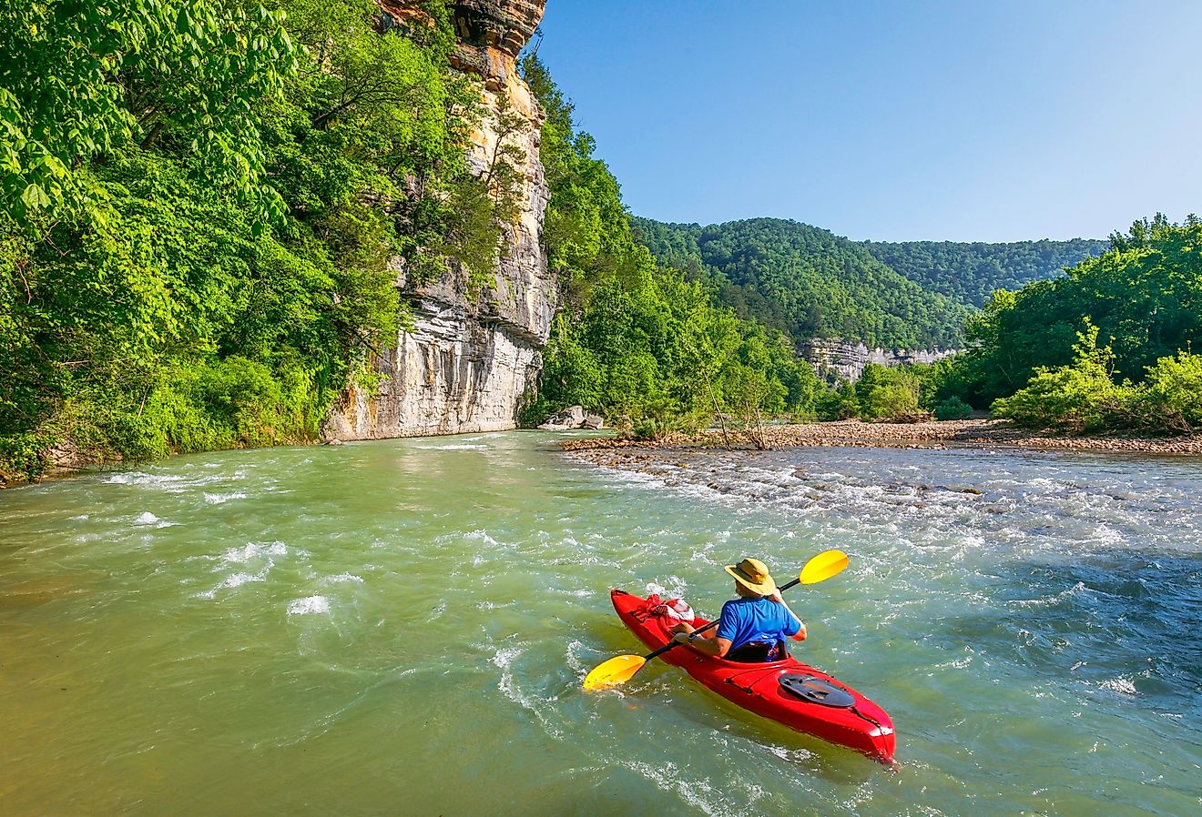 A kayaker is floating down the Buffalo River near Ponca, Arkansas.