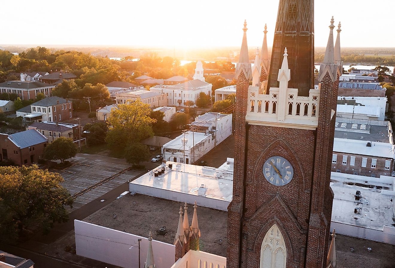 Sunset shines on a historic church and landscape of downtown Natchez, Mississippi. Image credit Matt Gush via Shutterstock