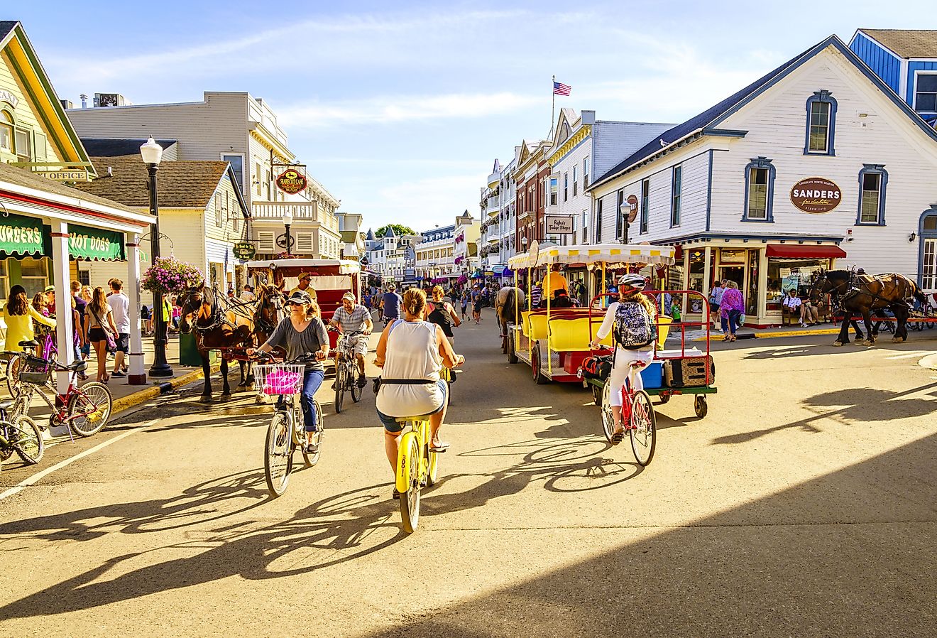 Vacationers take on Market Street on Mackinac Island that is lined with shops and restaurants. Image credit Alexey Stiop via Shutterstock.