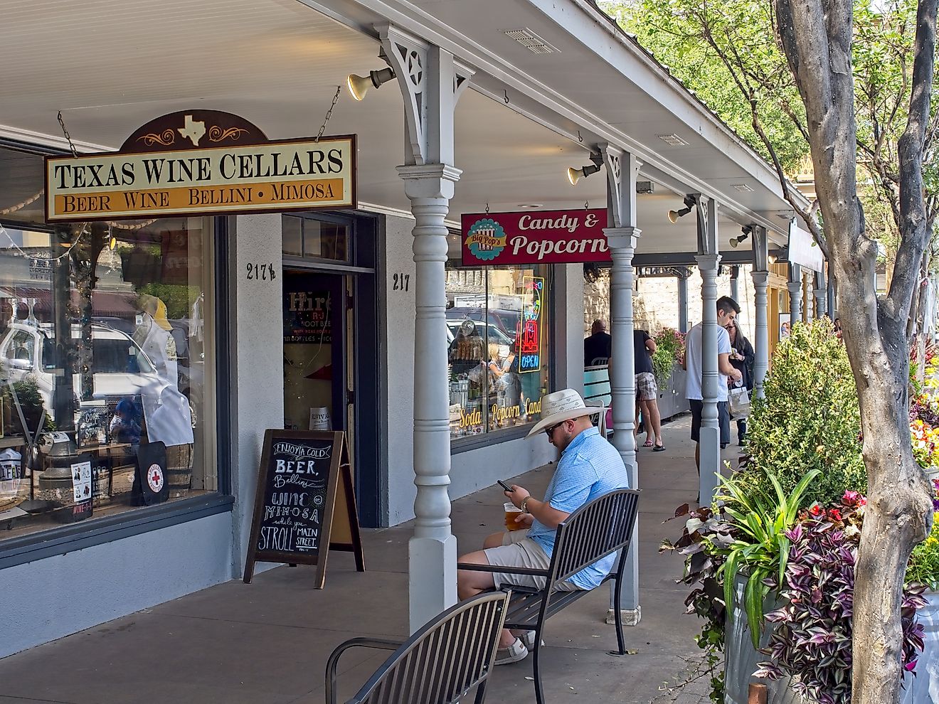 People walking around downtown Fredericksburg, Texas along the main street, via Peter Blottman Photography / iStock.com