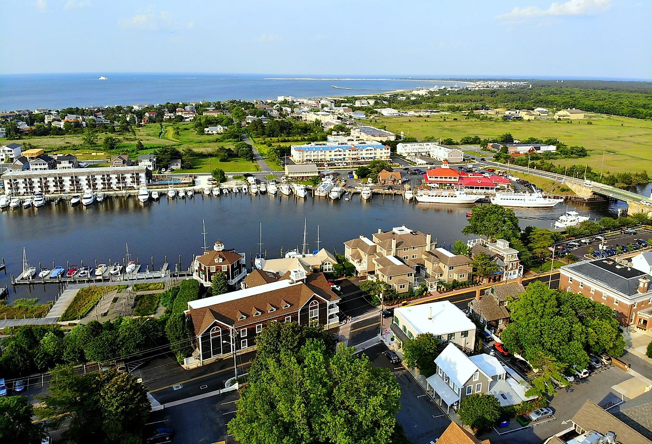The aerial view of the beach, fishing port and waterfront residential homes along the canal in Lewes, Delaware. Image credit Khairil Azhar Junos via Shutterstock