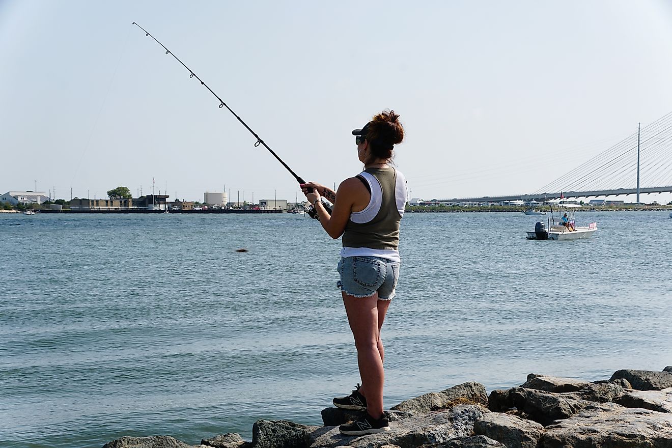 Outdoorsman casts her line on Bethany Beach in Delaware, USA