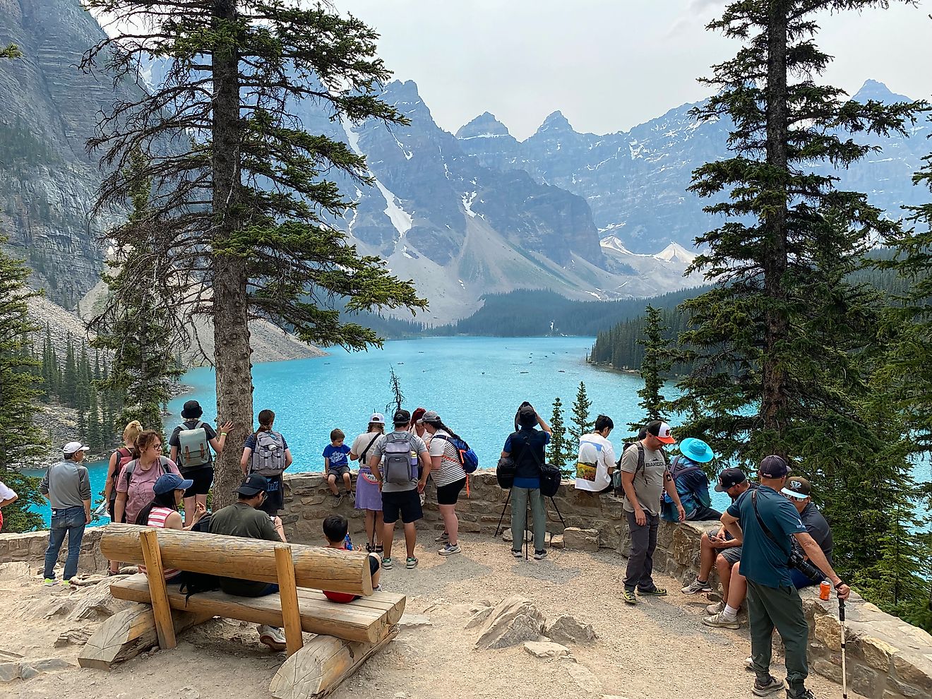 A crowded lookout above the Moraine Lake in Banff National Park. Its bright blue waters and surrounding Rocky Mountain peaks always draws summer crowds.