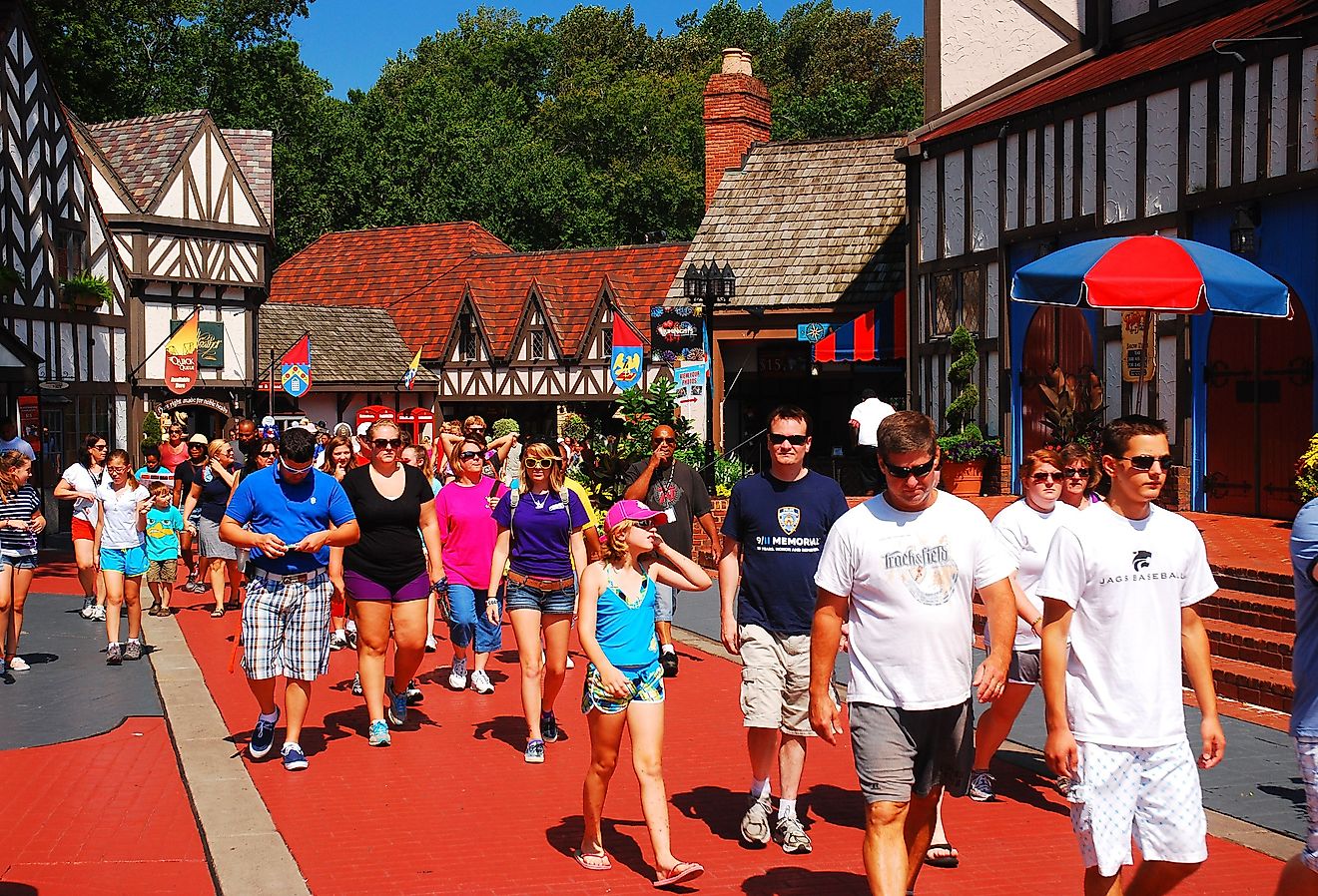 A crowd of people make their way through a recreated Tudor Village in Busch Gardens, in Williamsburg, Virginia. Image credit James Kirkikis via Shutterstock