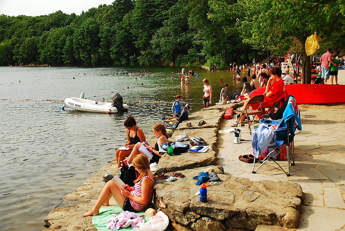 People enjoying their leisure time by the beautiful Walden Pond in Concord, Massachusetts.