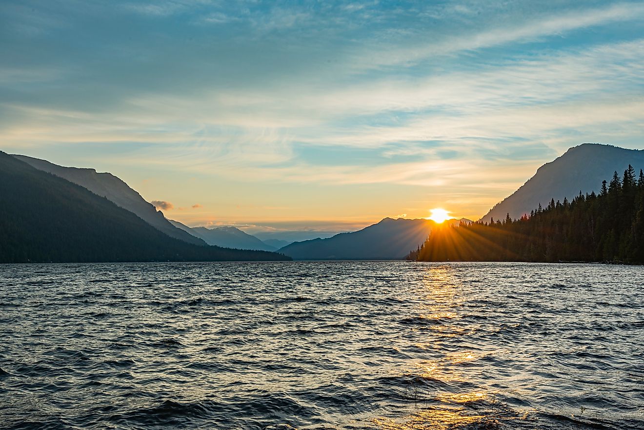 Sunset at Lake Wenatchee State Park, Washington, with the sky glowing in warm hues over the calm lake and surrounding mountains.