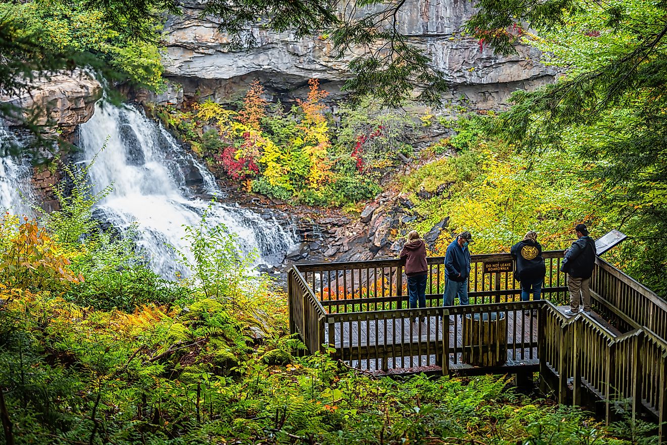 Blackwater Falls in Blackwater Falls State Park, West Virginia, during the autumn season with people at the overlook. Editorial credit: Kristi Blokhin / Shutterstock.com