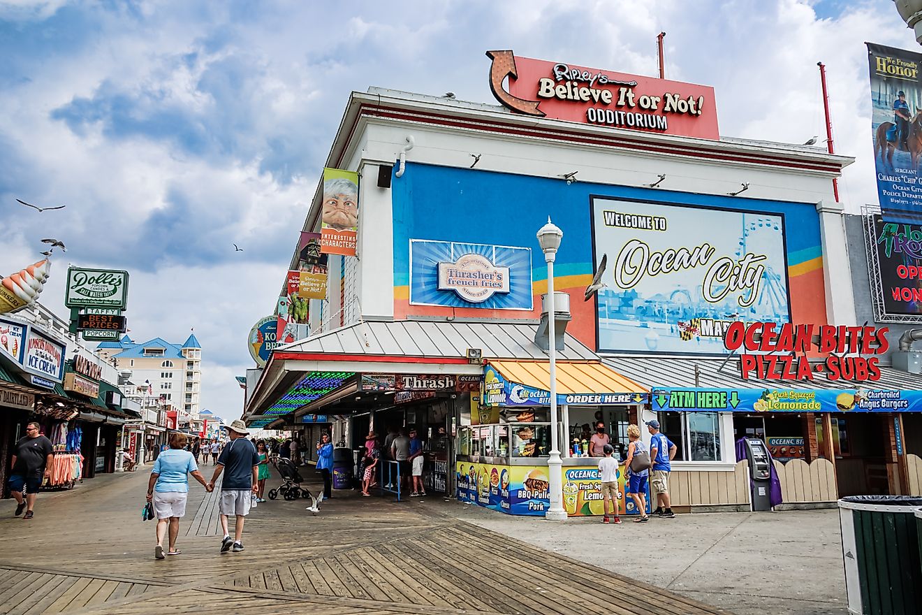 Tourists walking along shops, attractions, and food establishments on the boardwalk in Ocean City, Maryland. Editorial credit: eurobanks / Shutterstock.com