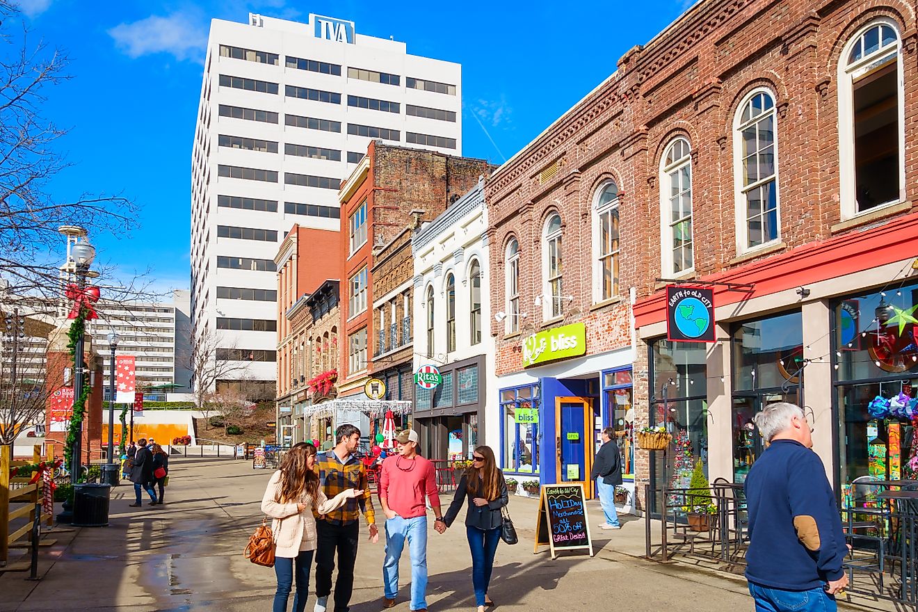 Knoxville, Tennessee: Pedestrians walk past colorful restaurants, bars and businesses on Market Square in downtown Knoxville, Tennessee, via benedek/iStock.com