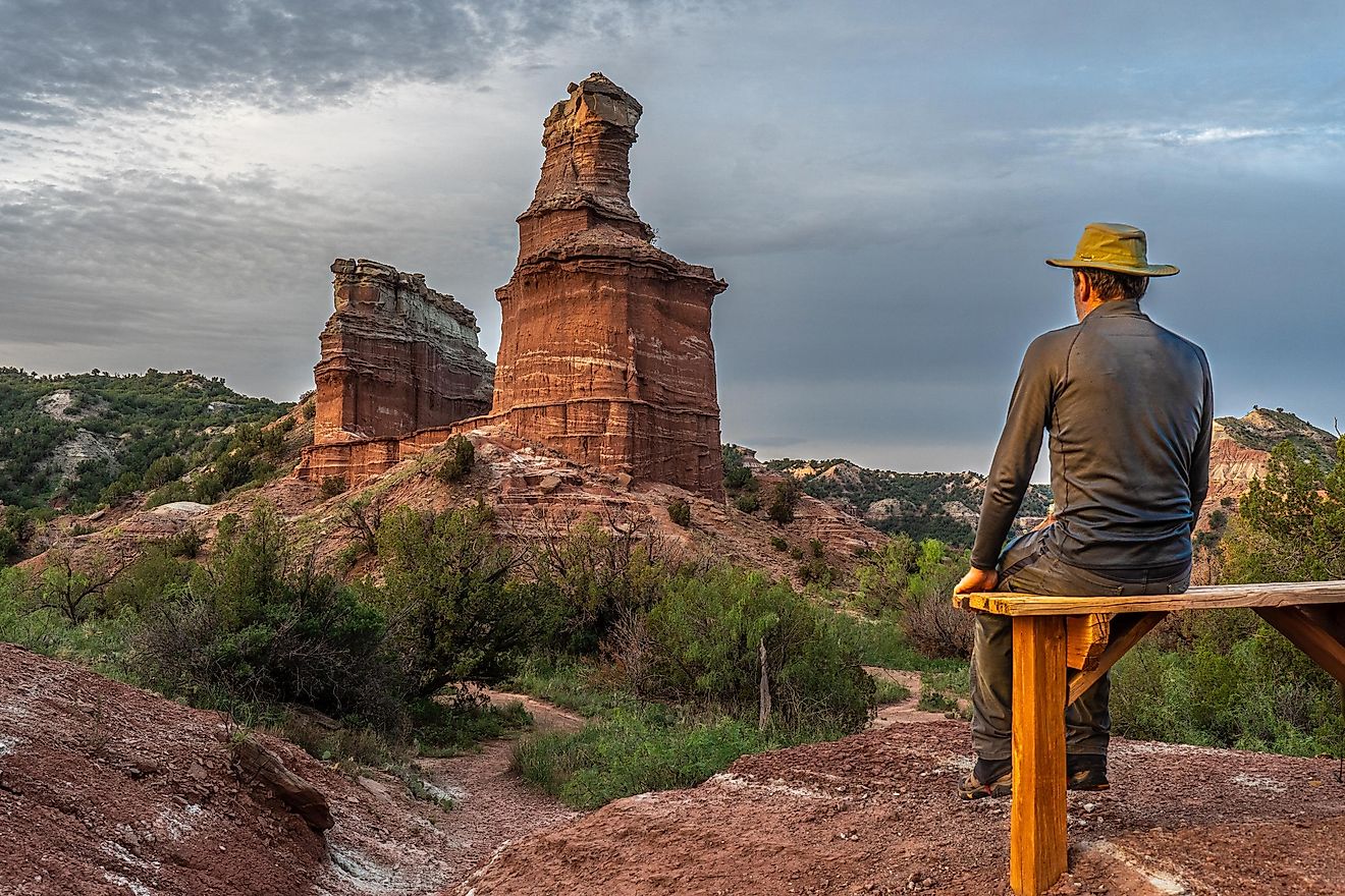 Man in the foreground of Lighthouse Trail at Palo Duro Canyon State Park, Texas. 