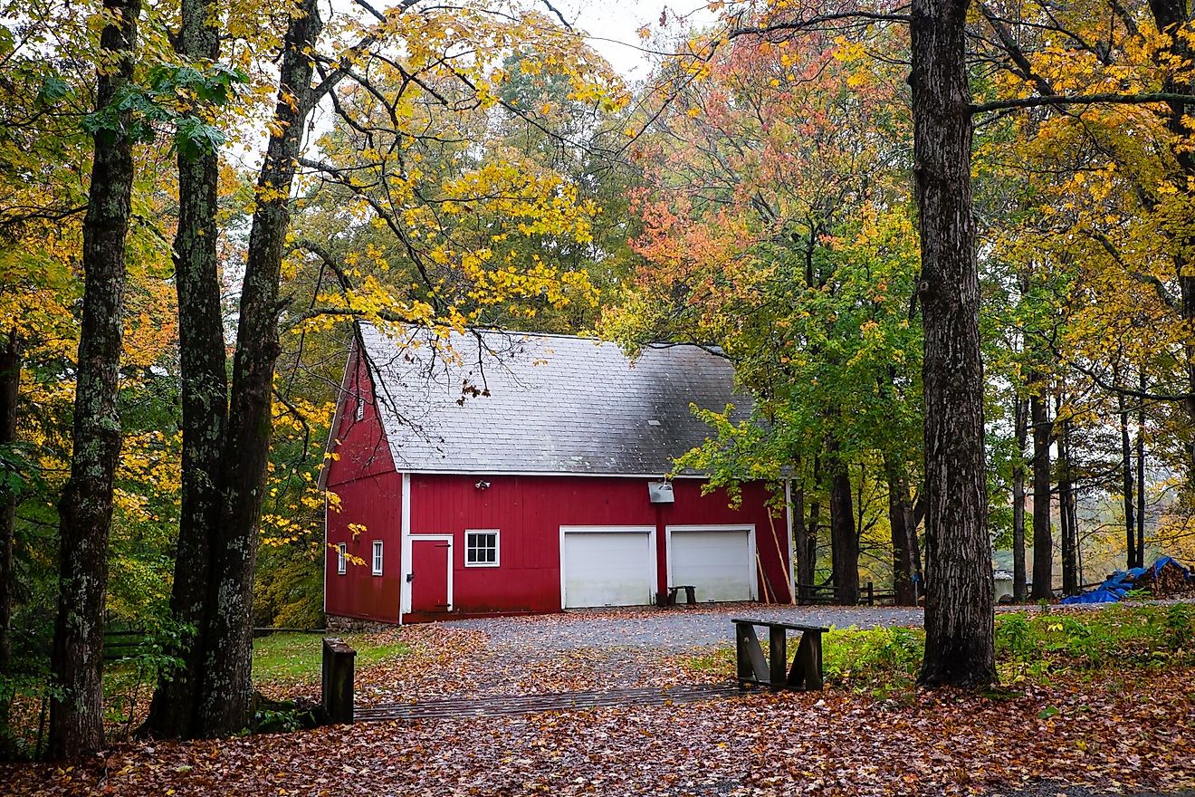 A beautiful red house is surrounded by fall colors in Manchester, Vermont. Editorial credit: Ye Choh Wah / Shutterstock.com